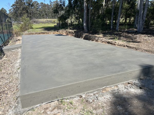 Large concrete slab on a bush block surrounded by trees